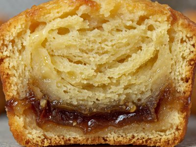 Close-up of a sliced banana muffin with a dark, translucent gummy streak along the bottom third
