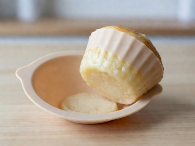 Muffin removed from a flexible silicone mold showing a pale, soggy, unbrowned bottom and sides